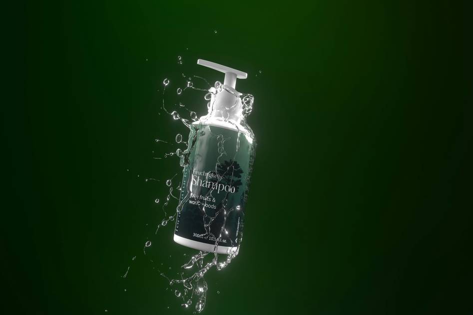Elegant body wash bottles with soft foam on marble surface